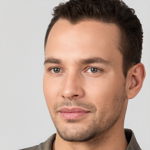 Joyful white young-adult male with short  brown hair and brown eyes