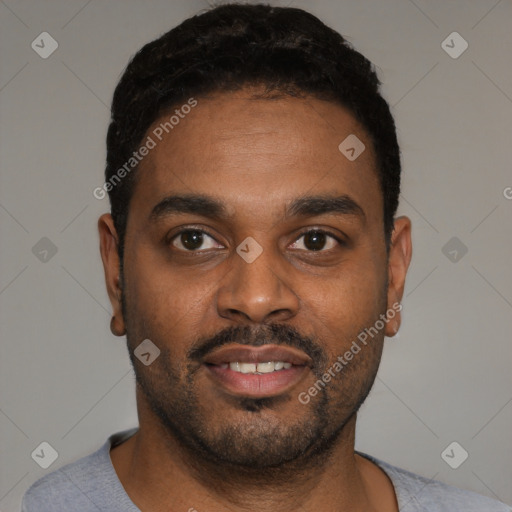 Joyful black young-adult male with short  black hair and brown eyes