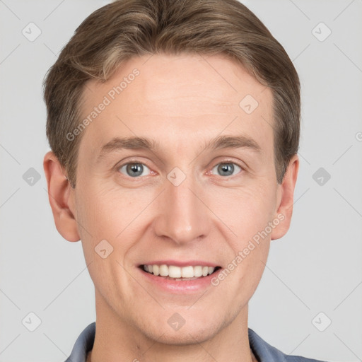 Joyful white adult male with short  brown hair and grey eyes