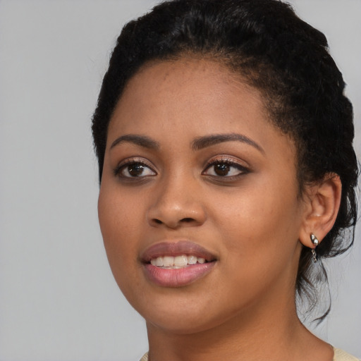 Joyful latino young-adult female with short  black hair and brown eyes