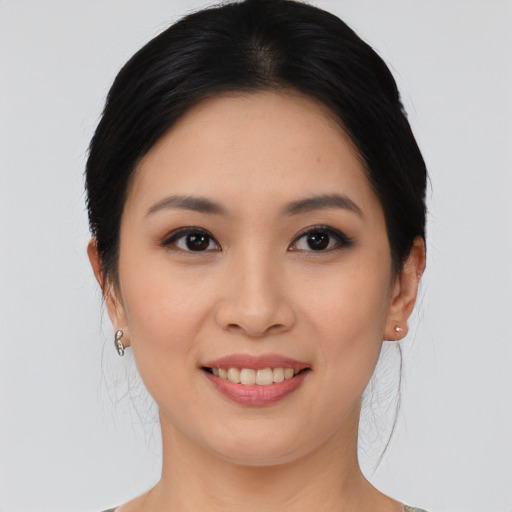 Joyful asian young-adult female with medium  black hair and brown eyes