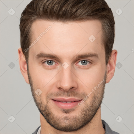 Joyful white young-adult male with short  brown hair and grey eyes