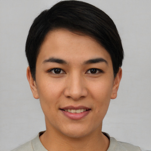 Joyful latino young-adult female with short  black hair and brown eyes