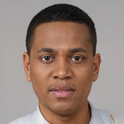 Joyful latino young-adult male with short  brown hair and brown eyes