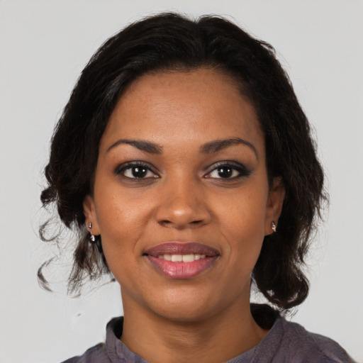 Joyful black young-adult female with medium  brown hair and brown eyes