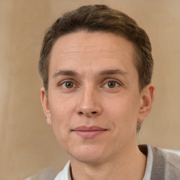 Joyful white adult male with short  brown hair and brown eyes