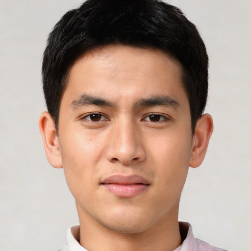 Joyful asian young-adult male with short  brown hair and brown eyes