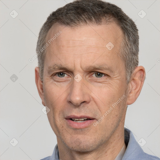 Joyful white middle-aged male with short  brown hair and brown eyes