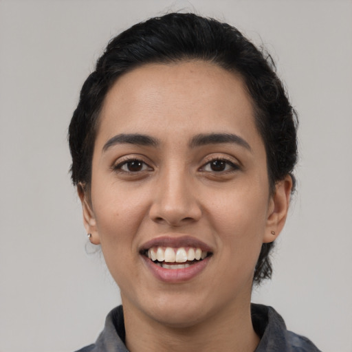 Joyful latino young-adult female with medium  black hair and brown eyes