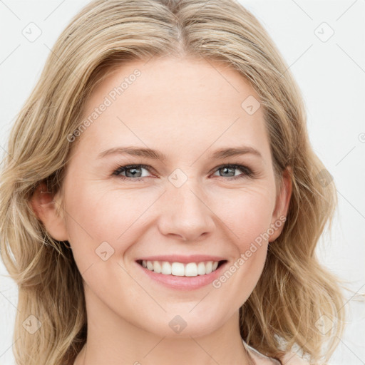 Joyful white young-adult female with long  brown hair and blue eyes