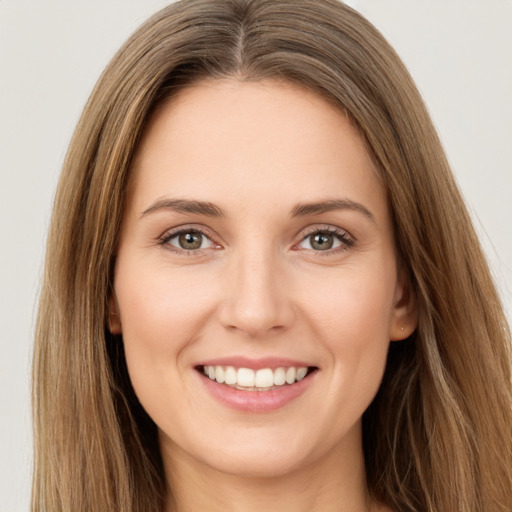 Joyful white young-adult female with long  brown hair and brown eyes