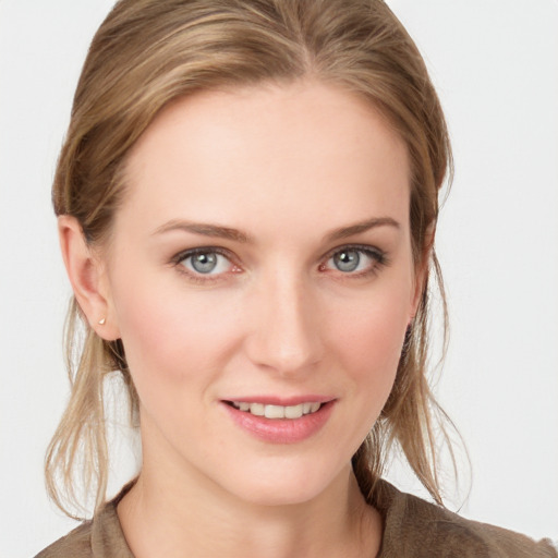 Joyful white young-adult female with medium  brown hair and blue eyes