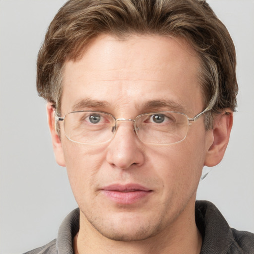 Joyful white adult male with short  brown hair and grey eyes