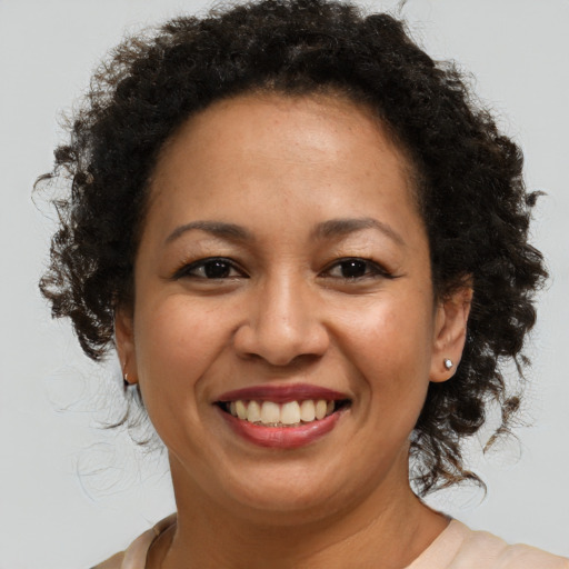 Joyful black adult female with medium  brown hair and brown eyes