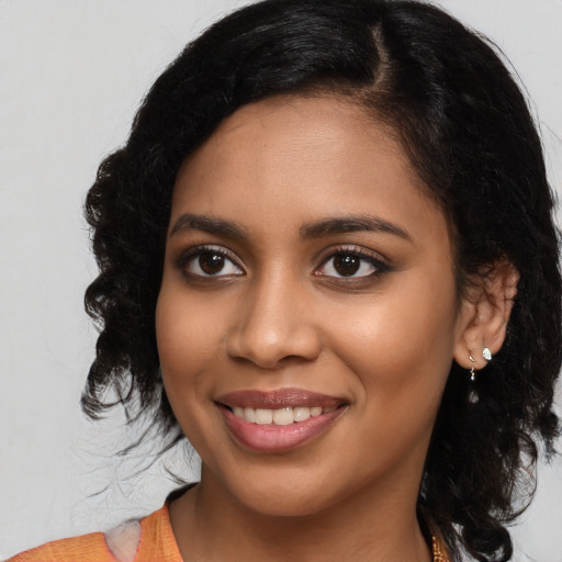 Joyful latino young-adult female with medium  black hair and brown eyes