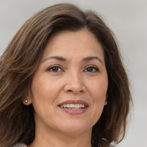 Joyful white adult female with medium  brown hair and grey eyes