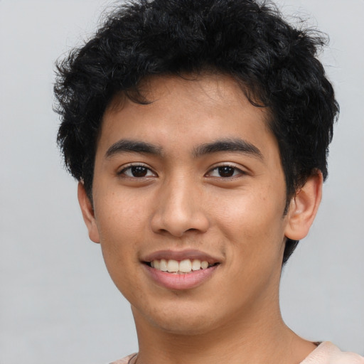 Joyful asian young-adult male with short  black hair and brown eyes