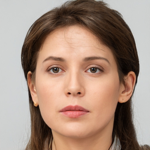 Neutral white young-adult female with long  brown hair and brown eyes