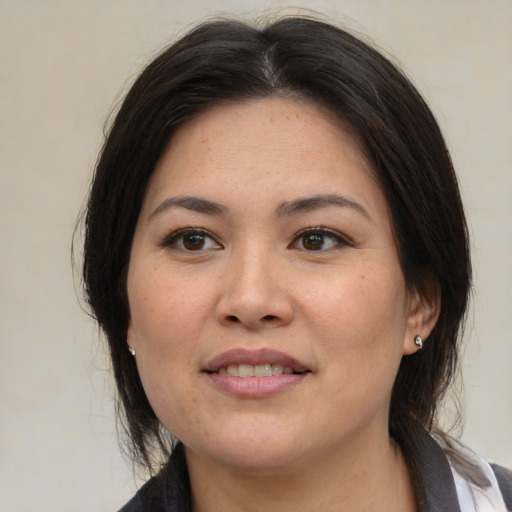 Joyful asian young-adult female with medium  brown hair and brown eyes