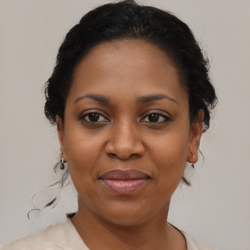 Joyful black young-adult female with medium  brown hair and brown eyes