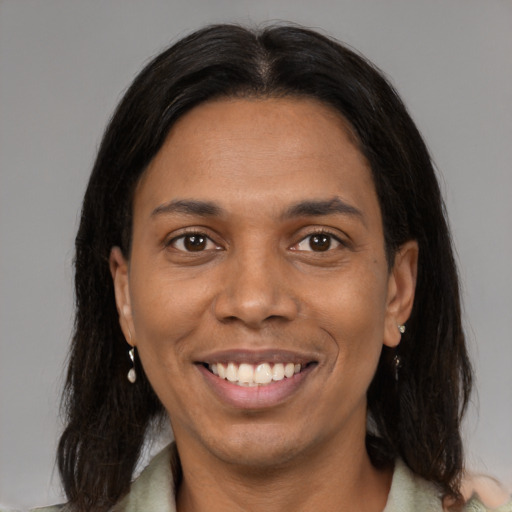 Joyful black young-adult female with medium  brown hair and brown eyes