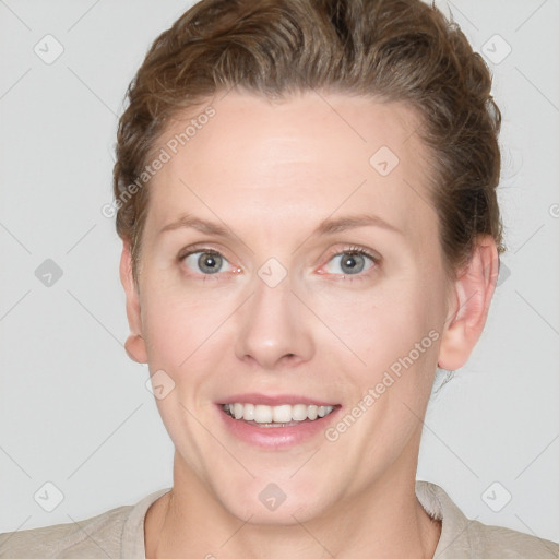 Joyful white young-adult female with short  brown hair and grey eyes