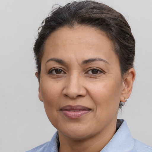 Joyful latino adult female with short  brown hair and brown eyes
