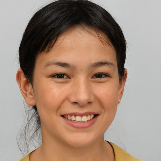 Joyful asian young-adult female with medium  brown hair and brown eyes