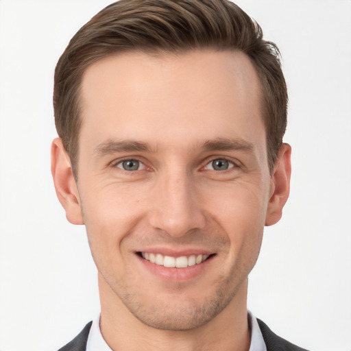 Joyful white young-adult male with short  brown hair and grey eyes