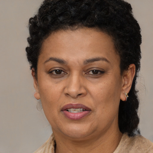 Joyful latino adult female with short  brown hair and brown eyes