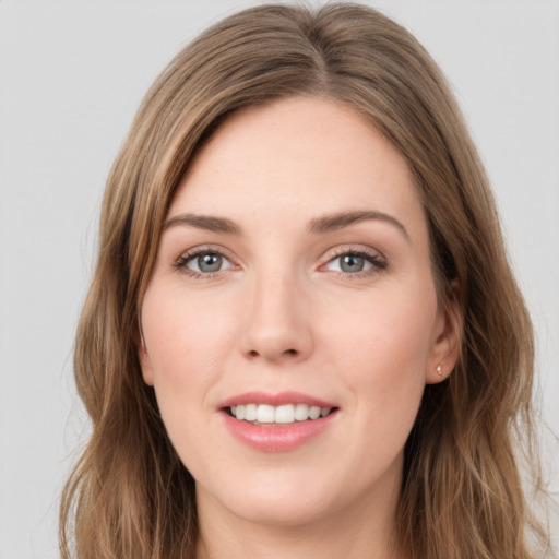 Joyful white young-adult female with long  brown hair and green eyes