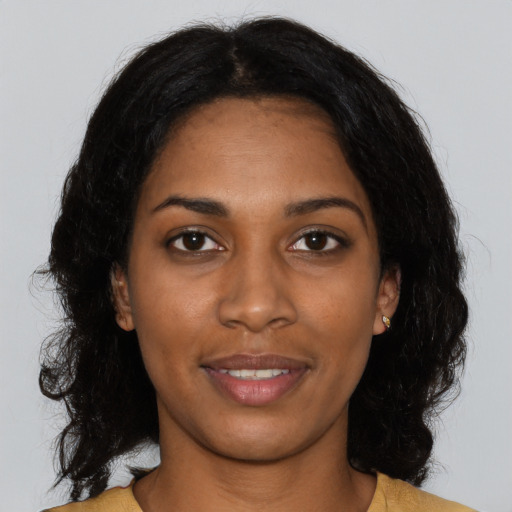 Joyful black young-adult female with medium  black hair and brown eyes