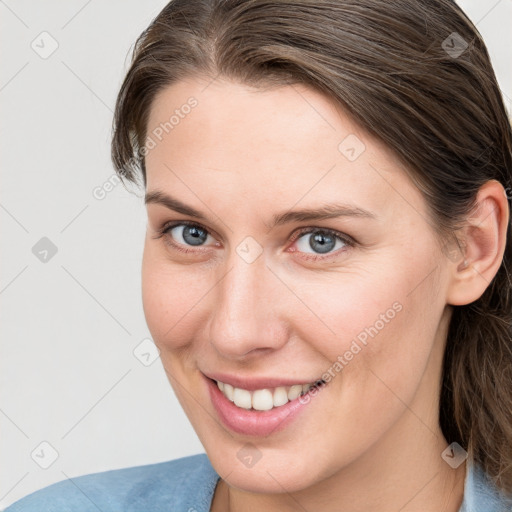 Joyful white young-adult female with medium  brown hair and blue eyes