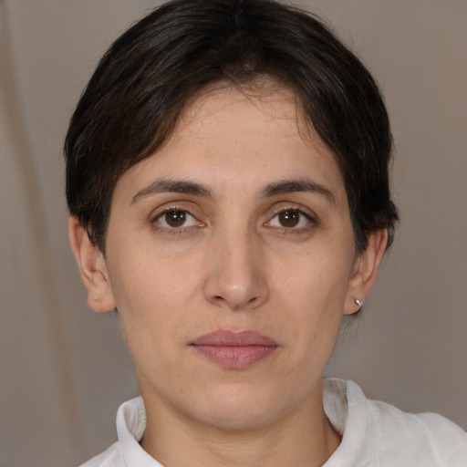Joyful white young-adult female with short  brown hair and brown eyes