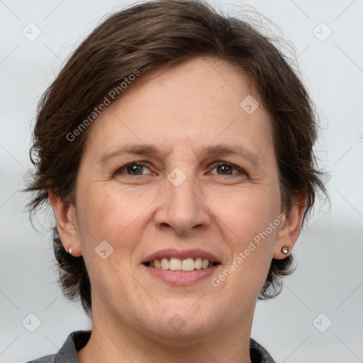 Joyful white adult female with medium  brown hair and grey eyes