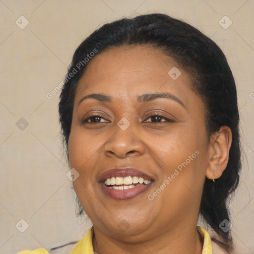 Joyful latino adult female with medium  brown hair and brown eyes