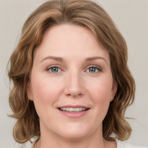 Joyful white young-adult female with medium  brown hair and green eyes