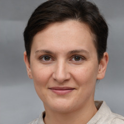 Joyful white young-adult female with short  brown hair and grey eyes