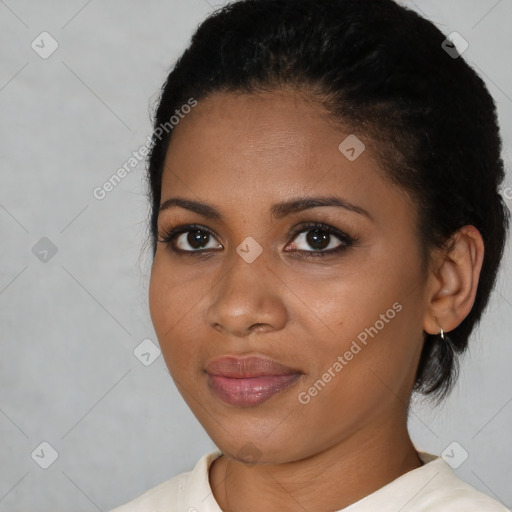 Joyful black young-adult female with short  black hair and brown eyes