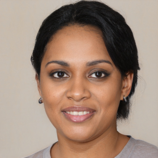 Joyful black young-adult female with medium  black hair and brown eyes