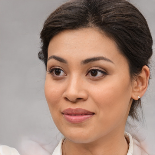 Joyful asian young-adult female with medium  brown hair and brown eyes