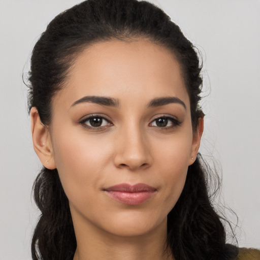 Joyful latino young-adult female with long  brown hair and brown eyes