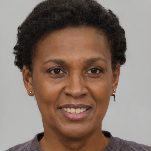 Joyful black adult female with short  brown hair and brown eyes