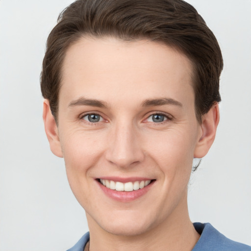 Joyful white young-adult female with short  brown hair and grey eyes