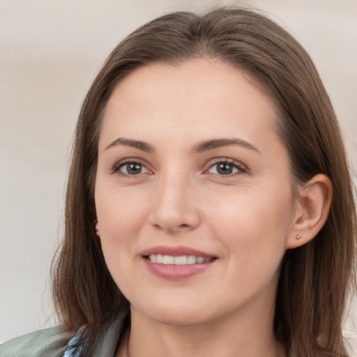 Joyful white young-adult female with medium  brown hair and brown eyes