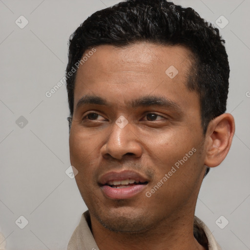 Joyful latino young-adult male with short  black hair and brown eyes