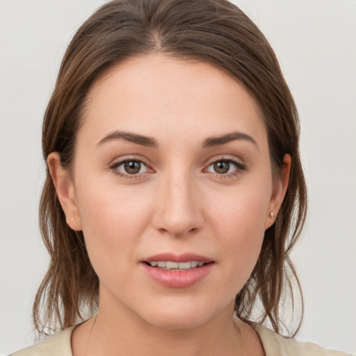 Joyful white young-adult female with medium  brown hair and grey eyes