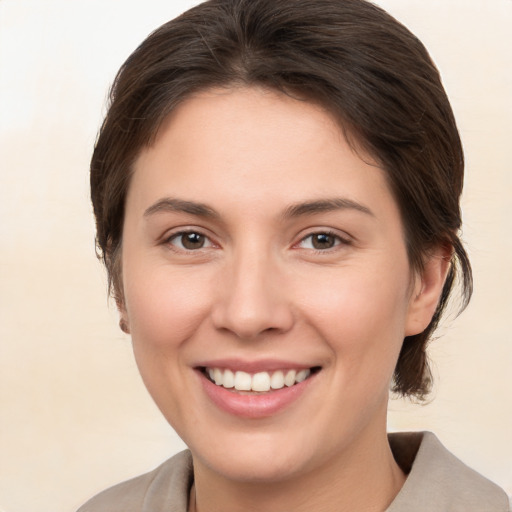 Joyful white young-adult female with medium  brown hair and brown eyes