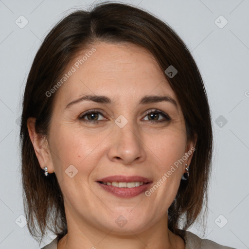 Joyful white adult female with medium  brown hair and brown eyes