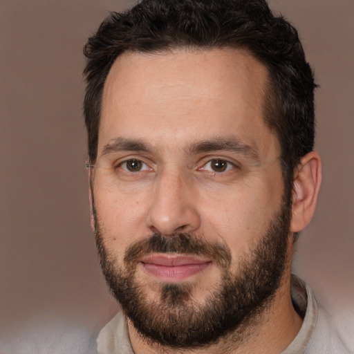 Joyful white adult male with short  brown hair and brown eyes